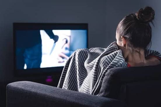 woman watching horror movie